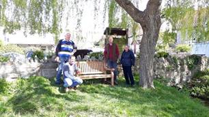 A group of people posing for a picture in front of a treeDescription automatically generated with medium confidence